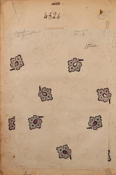 an old piece of paper with black and white designs on it, in the shape of flowers