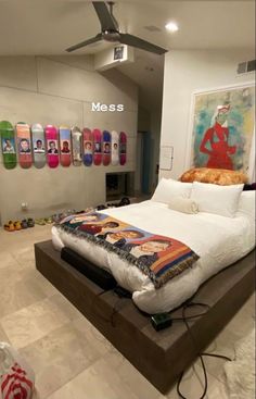 there is a large bed with many skateboards on the wall behind it in this room