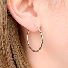 Model is wearing 30mm diameter hoop earrings, 925 Sterling Silver: size medium. * Comes as a pair--a left and right side, each hammered on one side. * Also available in 14K gold filled, and 14K rose gold filled. * Made with 16 ga wire (1.3mm thick) * End of hoop is thinned out to about 21 gauge, to easily slip through ear * Hammered texture HOOP CLOSURE: * Latch back: end of the earring passes through a hole on the opposite side of the hoop, creating a continuous loop. OR * Butterfly clutch: hoo Big Gold Hoop Earrings, Gold Cartilage Earrings, Small Silver Hoop Earrings, Hoop Earrings Large, Wire Hoop Earrings, Rose Gold Hoop Earrings, Minimalist Earrings Gold, Tiny Hoop Earrings, Hammered Hoop Earrings