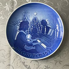 a blue plate with an image of people playing the piano