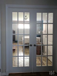 two white double doors with glass panels in a home's entryway and bedroom