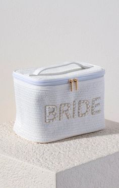 a white bag with the word bride written on it sitting on top of a block