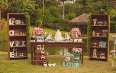 the table is set up with flowers and cakes on it, along with other decorations