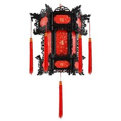 a red and black clock with chinese writing on it's face, hanging from the ceiling