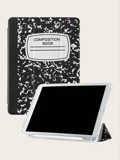 a black and white composition book with an ipad on the cover, next to it's holder