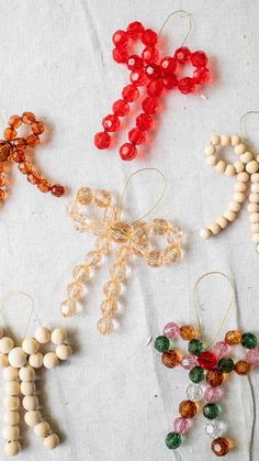 some beads are hanging from strings on a table