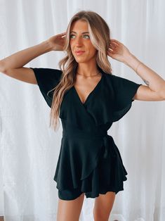 DETAILS: Our Kylah Wrap Romper is a wrap romper with self tie detail on one side for figure flattering customizable fit. This romper is completed with flowy short sleeves, back cut out detail. and wrap front for a dress look. This flowy romper features hidded side zipper closure. CONTENT & CARE: 50% Cotton, 50% Polyester SIZE & FIT: Model is 5'8" The model is wearing a size Small. Flowy Romper, Party Rompers, Wrap Romper, Flowy Shorts, Side Zipper, Rompers Women, Cut Out, Wrap Dress, Short Sleeves