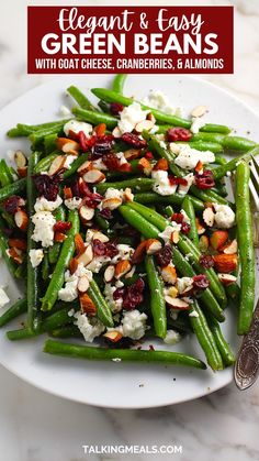 green beans with goat cheese, cranberries and almonds on a white plate