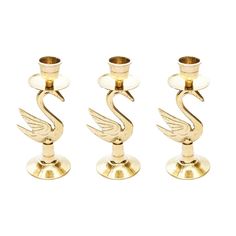 three brass candlesticks sitting next to each other