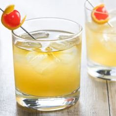 two glasses filled with lemonade and cherries