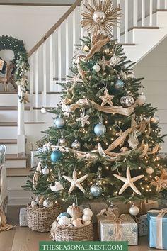 Coastal-themed Christmas tree with starfish, driftwood, and seashells, accented in blue and silver.