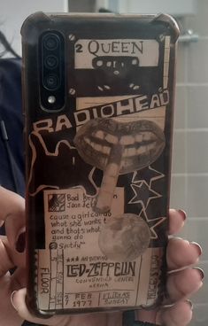 a person holding up a cell phone case with an image of a radiohead on it