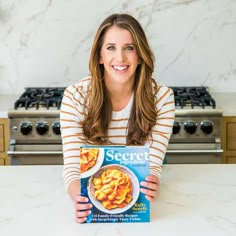 a woman holding up a box of cereal