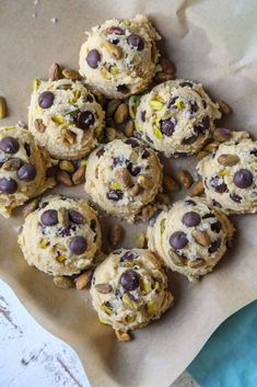 chocolate chip cookies with pistachios and almonds on parchment paper, ready to be eaten