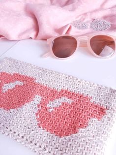 a pink and white rug with sunglasses on it