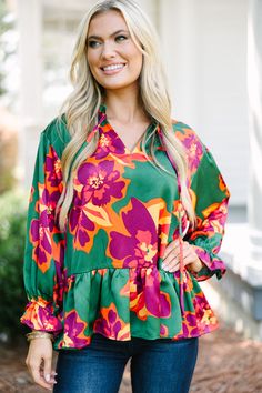 This bold floral blouse is sure to bring you all the joy! Those color are so eye-catching and we love the ruffled hemline. This blouse is going to look great with jeans for a cute yet casual look. 
Ruffled v-neckline with tied details 
Long sleeves with elastic cuff
Ruffled hemline
Floral print
Satin fabric
No stretch
Baileigh is wearing the small. Loose Knit Dress, Floral Embroidered Shirt, Green Floral Blouse, Long Sleeve Ruffle Dress, White Floral Blouse, Blouse Sale, Cute Spring Outfits, Casual Work Outfits, Long Puff Sleeves