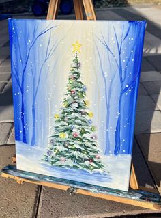 a painting of a christmas tree on an easel