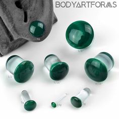 several green glass knobs are shown on a white background with the words bodyartfoams above them