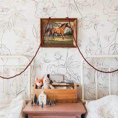 a bed room with two beds and a painting on the wall