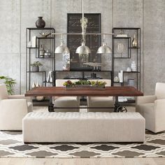 a dining room table with chairs and a bench in front of it on top of a rug