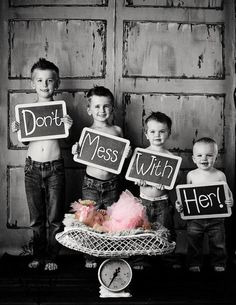 black and white photograph of three boys holding signs that say don't mess with her