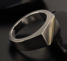 a silver ring sitting on top of a black table