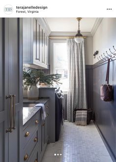 a narrow kitchen with gray cabinets and white tile flooring is featured in this magazine