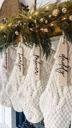 christmas stockings hanging from a mantel in front of a fireplace