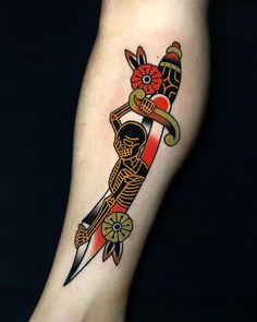 a tattoo on the leg of a person with a knife in it's hand