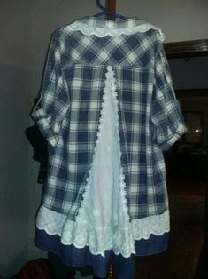 a blue and white checkered shirt hanging on a clothes rack