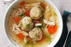 a bowl of soup with dumplings and carrots