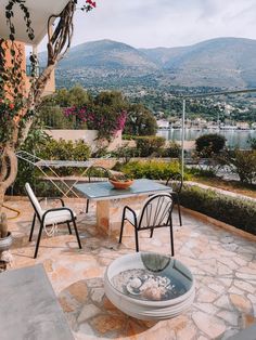 an outdoor dining area with table and chairs