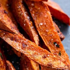 sweet potato wedges with parmesan cheese and seasoning on top, ready to be eaten