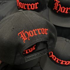 "HORROR HAT Black Snapback Hat Red Embroidery On Black Hat Black Under-Bill 3-D embroidery on the front with flat stitch on the back. Suggested Size Range: Fits hat sizes: 7 - 7 3/4 (22\"-24.25\")" Red Snapback Hip Hop Hat, Red Short Brim Trucker Hat For Streetwear, Red Trucker Hat With Short Brim For Streetwear, Horror Hat, Embroidery On Black, Black Snapback, Red Embroidery, City Design, Black Hat