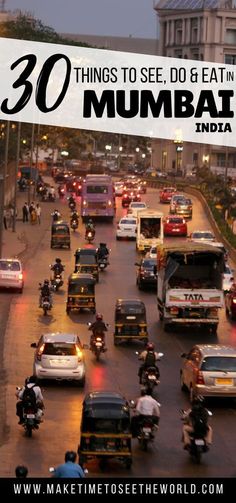 a busy street filled with lots of cars and motorcyclists driving down it