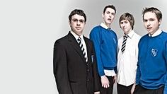 a group of young men standing next to each other in front of a white background