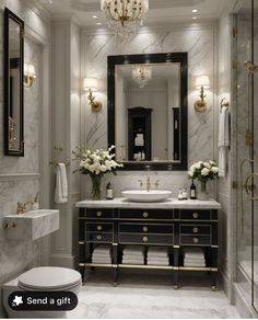 a fancy bathroom with marble counter tops and gold accents