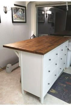 a kitchen island with drawers in the middle