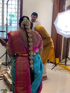 a woman in a sari standing next to a man