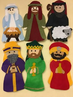 felt nativity figures are displayed on a table