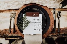 a place setting with napkins, forks and silverware