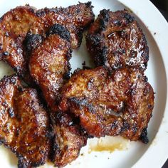 chinese barbecued pork steak on a white plate with text overlaying the image