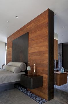 a bedroom with wood paneling on the wall