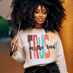 a woman holding an umbrella with the words trust in the lord on it