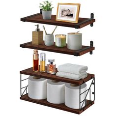 three tiered shelving unit with towels, soaps and other items on it