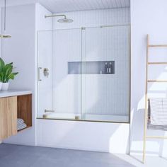 a bathroom with a sink, mirror and shower stall in the corner next to a bathtub