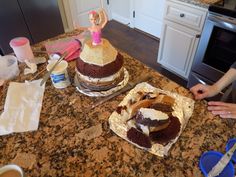 two large cakes sitting on top of a kitchen counter