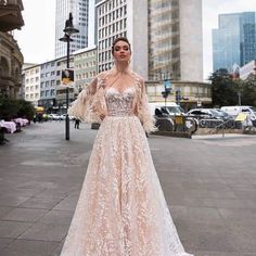 a woman in a wedding dress standing on the street