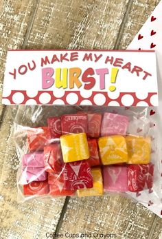 valentine's day treat bag with gummy bears in it and a sign that says you make my heart burst