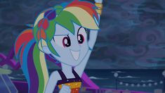 the rainbow - haired pony is smiling and holding a drink in her hand while standing next to the ocean